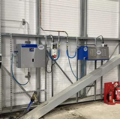 Nilfisk SC Uno and DTE pressure washers mounted on UniStrut framing at a logistics facility in Ellistown.